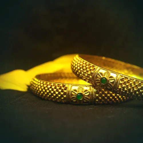 A matched pair of 22 carat gold kada bangles with emerald cabochons.