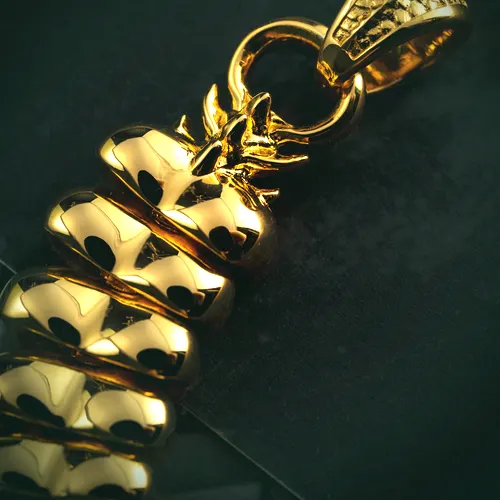 A heavy 22 carat gold link chain with a carved clasp, on a dark ground.